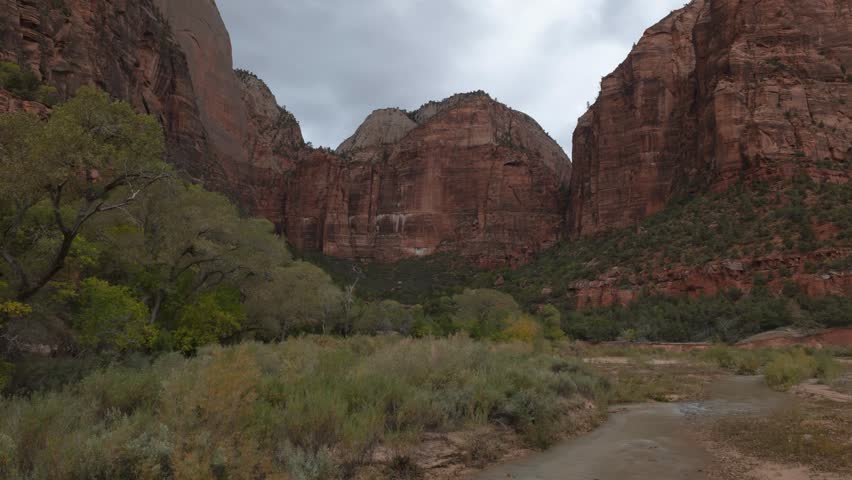 4k time lapse video of stormy weather in Zion NP Utah USA with the Virgin River in front of the cliffs above the Emerald Pools on an autumn day.