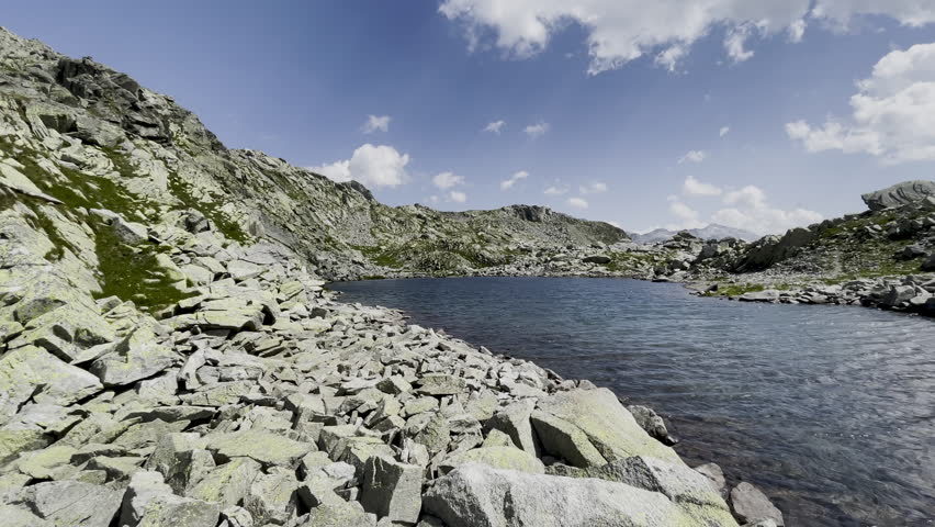 Alpine lake with mountain and scree landscape - Italian Alps