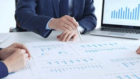 Business people colleagues analyzing financial reports and corporate data on paper charts and a laptop screen during a meeting, discussing market strategy and project results in office - Powered by Shutterstock - Get 15% off with code: PIKWIZARD15