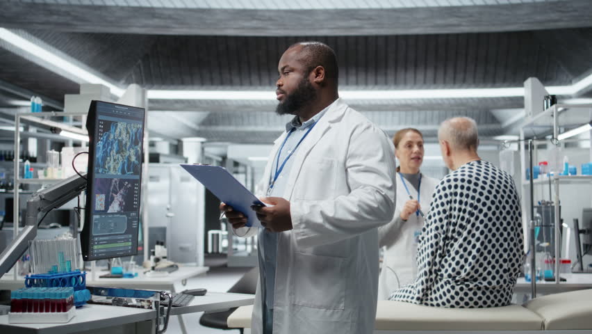 Black doctor conducts clinical trial in a research lab and observing patient during drug testing, recording dosage reactions and analyzing data to evaluate safety or risk. Camera A.