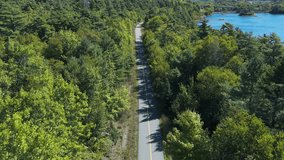 Triathlete In Helmet Cycles On A Scenic Path Next To A Sparkling Lake And Green Forest. Aerial View From Above Shows Summer Fitness Recreation, Eco-Friendly Travel, And Solitude In Nova Scotia Nature. - Powered by Shutterstock - Get 15% off with code: PIKWIZARD15