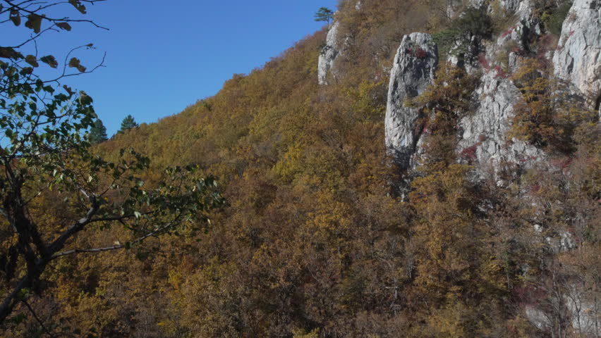 Mountain Landscape Autumn: Rocky mountain with trees in a natural setting during daytime for scenery and nature.