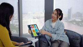 In a modern office, Asian businesswoman presents data summary charts on a tablet to her colleagues, financial report analysis teamwork strategy planning corporate success, marketing, data analytics - Powered by Shutterstock - Get 15% off with code: PIKWIZARD15