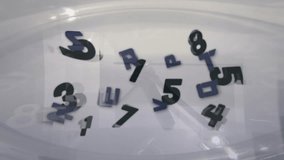 Magnetic stir bar spinning under container, forming vortex lifting numbers and letters for mixing. Fluid dynamics, vortex motion, particle suspension, laboratory equipment, abstract science, - Powered by Shutterstock - Get 15% off with code: PIKWIZARD15