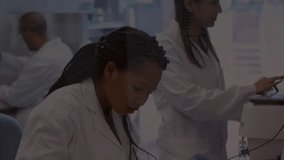 Lab researcher lifting pipette dispensing droplets as peer tapping screen initiating binary overlay. Science, innovation, technology, precision, collaboration, laboratory, data - Powered by Shutterstock - Get 15% off with code: PIKWIZARD15