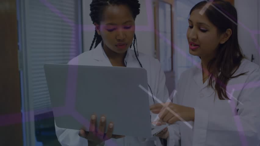 Lab scientists holding laptop using stylus activating holographic overlays for research analysis. Futuristic, collaboration, innovation, technology, education, analytics, professional - Powered by Shutterstock - Get 15% off with code: PIKWIZARD15