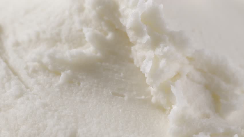 Macro view of raw shea butter texture, creamy and soft, styled close for skincare cosmetic ingredient photography concept.