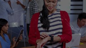 woman scrolling smartwatch showing data overlay in business meeting with colleagues at flip chart. Technology, collaboration, innovation, digital, modern, teamwork, professional - Powered by Shutterstock - Get 15% off with code: PIKWIZARD15