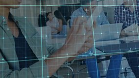 Man scrolling tablet initiating pulsing grid as colleague typing laptop in team tech meeting. Technology, collaboration, innovation, digital, communication, professional, teamwork - Powered by Shutterstock - Get 15% off with code: PIKWIZARD15