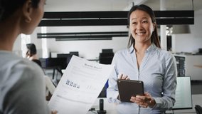 Younger member handing business report to senior colleague initiating spinning globe for review. Corporate, teamwork, professional, collaboration, modern, digital, communication - Powered by Shutterstock - Get 15% off with code: PIKWIZARD15
