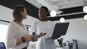 Two coworkers initiating office discussion by laptop and mug summoning data icons for sharing ideas. Collaboration, teamwork, innovation, communication, professional, productivity, modern - Powered by Shutterstock - Get 15% off with code: PIKWIZARD15