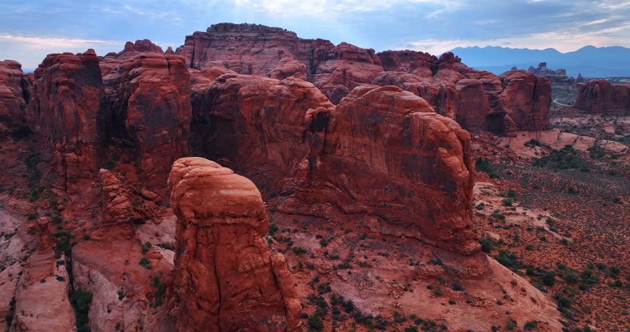 Flight around the stunning red rocks in the dry desert. Spectacular canyons of the Arches National Park, Utah, USA from drone.