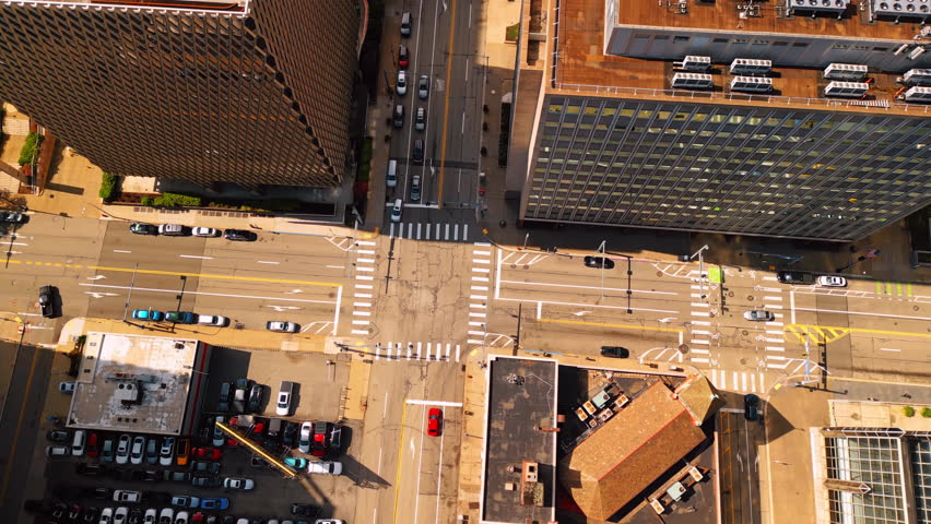 Crossroad among the high-rise buildings in the city. Top view. Lots of cars stand at the parking lot. Pittsburgh, Pennsylvania, USA.