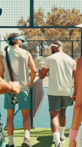 Group of friends, start and padel match on court, outdoor activity or fist bump for training practice. Support, racket cheers or people walk on tennis turf for friendly game, ready and play together