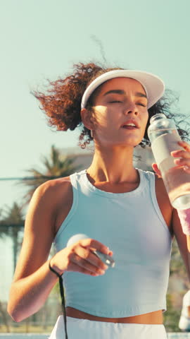 Tennis court, woman and drinking water for health, sports and wellness outdoor. Athlete, hydration and person with bottle for fitness with padel player, thirst and liquid nutrition for recovery
