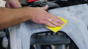 Technician hand polishes car overall detail with sandpaper piece in repair shop closeup. Worker renovates vehicle part manually at service station - Powered by Shutterstock - Get 15% off with code: PIKWIZARD15