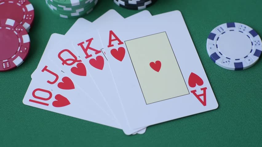 Playing card game poker in casino with chips, bets and risk. Cards and chips on green felt as background for your design