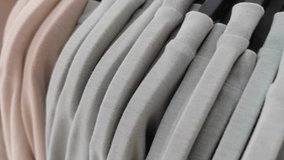 Close-up of soft pastel tone clothes neatly arranged on hangers in a fashion boutique. The image highlights textile texture, minimal design, and modern retail aesthetics. Perfect for illustrating - Powered by Shutterstock - Get 15% off with code: PIKWIZARD15