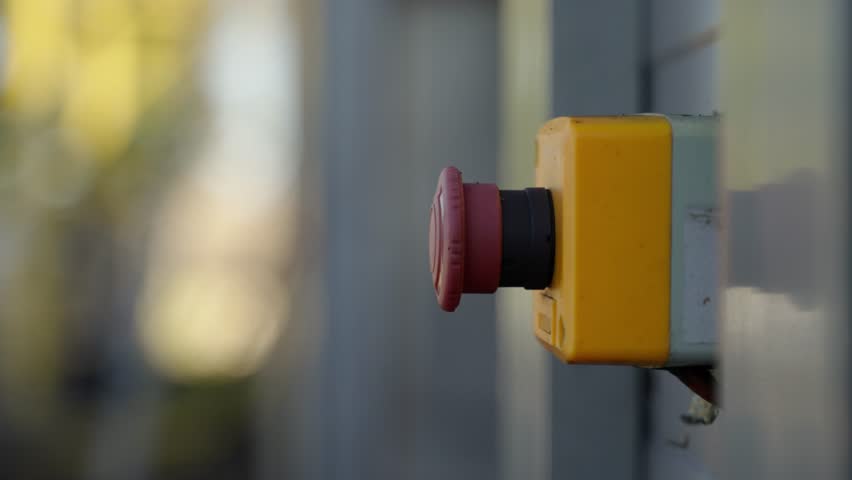 Man hand pressing red industrial button in slow motion