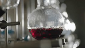 Boiling red wine in round laboratory flask in slow motion - Powered by Shutterstock - Get 15% off with code: PIKWIZARD15