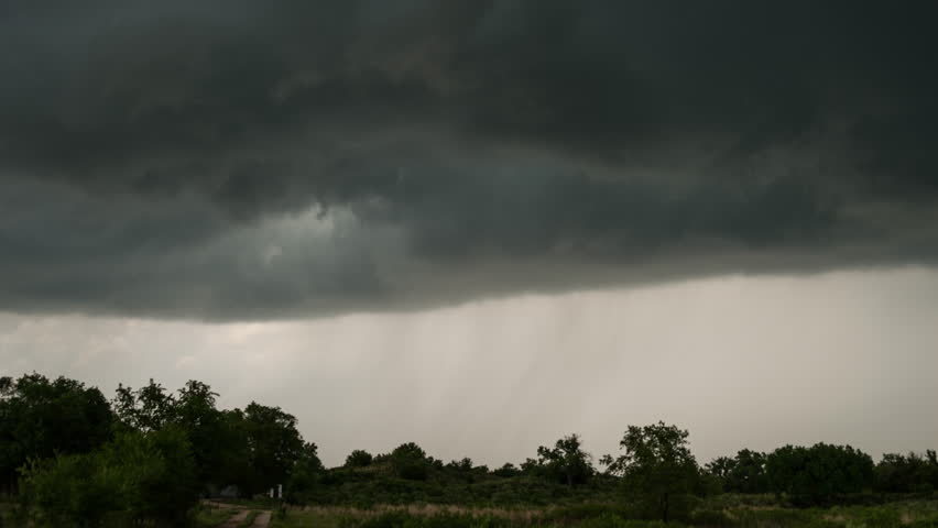 Ominous Stormy Sky With Rotating Wall Cloud Over Trees - real footage, long duration, cinematic 4K