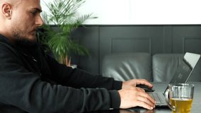 Startup founder working remotely from cozy home office with tea mug. Modern interior, focused workflow, relaxed vibe. Perfect for productivity, tech lifestyle, or remote startup footage. - Powered by Shutterstock - Get 15% off with code: PIKWIZARD15