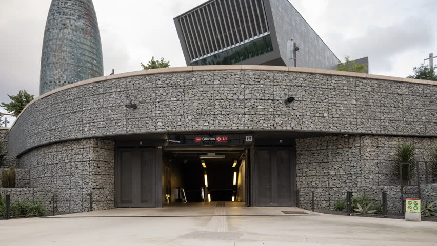 Timelapse of Glories Metro Station In Barcelona and skyline 