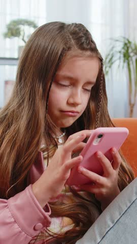 Upset girl using smartphone playing game loses becoming surprised sudden lottery results, bad news, fortune loss, fail education study test. Female teen child kid at home in living room sits on sofa.