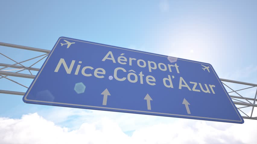 Bright blue motorway indicator toward Nice Cote dAzur Airport with jetliner gliding toward the runway, arriving to Nice, France.