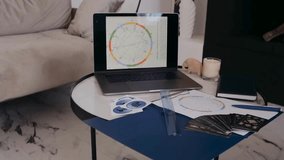 Astrology workspace features modern laptop displaying intricate charts and graphs. Various stationery items include rulers, papers, and tarot cards. Calm, cozy atmosphere enhances creativity. - Powered by Shutterstock - Get 15% off with code: PIKWIZARD15
