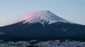 Stunning view of Mount Fuji illuminated by soft morning light. Snow-covered peak contrasts with clear sky, showcasing tranquil town below. Perfect winter serenity captured. - Powered by Shutterstock - Get 15% off with code: PIKWIZARD15