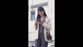 Young happy business businesswoman walking outdoor smiling using modern smartphone technology traveling on bustling city street near contemporary office buildings enjoying day. - Powered by Shutterstock - Get 15% off with code: PIKWIZARD15