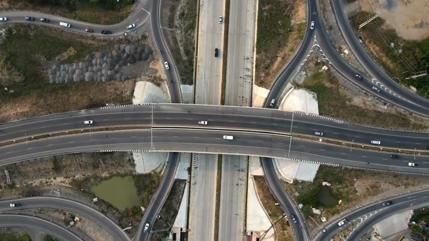 Discover dynamic intersections with flowing traffic in this aerial perspective of a modern highway system, showcasing infrastructure and urban development.