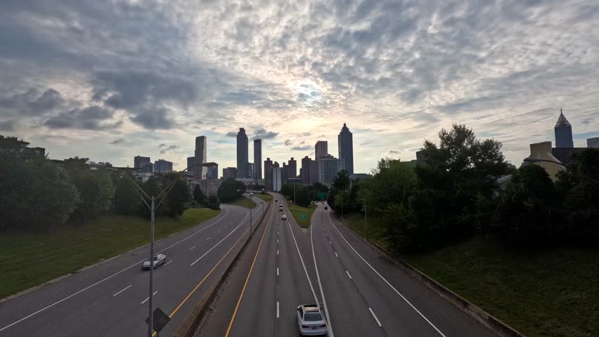 A 4K daytime time-lapse video of the Atlanta, Georgia city skyline, captured from the Jackson Street Bridge. Features downtown skyscrapers, city streets, and moving clouds, showcasing the energy and a