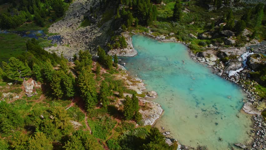 Aerial view nature landscape turquoise Kuyguk waterfall and Kuiguk lake with clear blue water from glaciers in Altai mountains, Siberia Russia.
