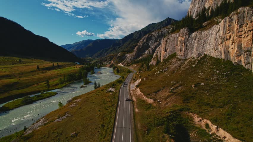 Aerial view Adventure travel car is driving along winding mountain road in Altai nature reserve.