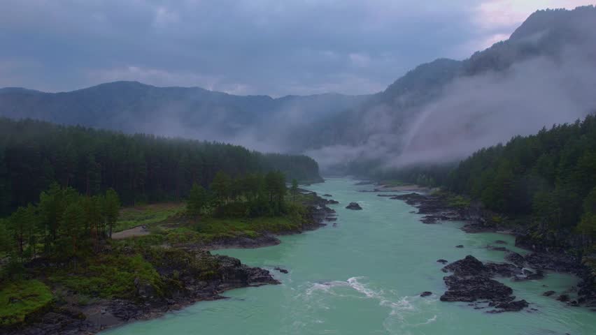 Evening landscape Altai mountains summer Russia, aerial top view. Blue Katun river with destroyed suspension bridge after flood, fog mood.