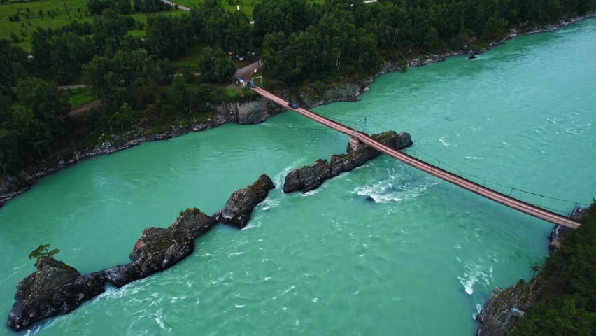 Blue river Katun in Altay, Siberia Russia. Landscape popular tourist place Dragon Teeth and suspension bridge.
