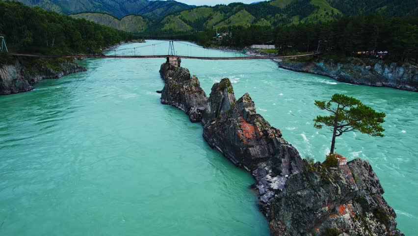 Aerial view Blue river Katun in Altay, Siberia Russia. Landscape popular tourist place Dragon Teeth and suspension bridge.