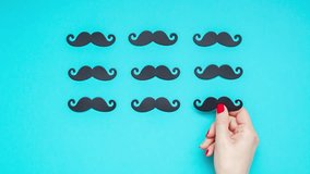 Creative flatlay overhead top view retro stylish black paper photo booth props moustaches turquoise female hand background copy space. Men health awareness month fathers day masculinity concept - Powered by Shutterstock - Get 15% off with code: PIKWIZARD15