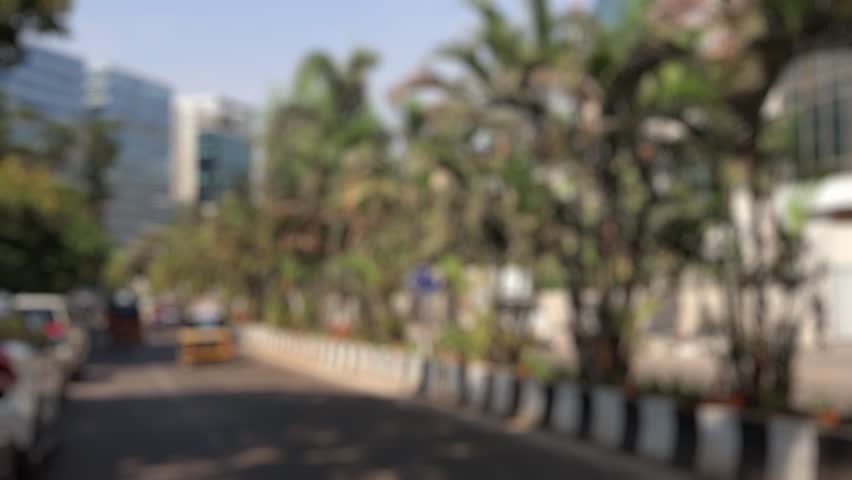 Bokeh view of road traffic in Bandra Kurla Complex area - commercial district of Mumbai, India. Blurred background footage.
