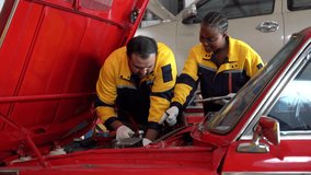 diverse team of Indian mechanic man and african american engineer woman collaborates on an engine inspection of a classic red car a garage car service . teamwork checkup in auto repair shop - Powered by Shutterstock - Get 15% off with code: PIKWIZARD15