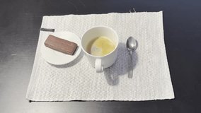 A cozy, intimate video capturing the process of stirring and enjoying a cup of coffee paired with a piece of chocolate. Perfect for food blogs, café promotions, and lifestyle content. - Powered by Shutterstock - Get 15% off with code: PIKWIZARD15