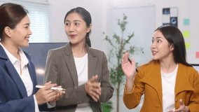 Businesswoman congratulating colleague for successful presentation. - Powered by Shutterstock - Get 15% off with code: PIKWIZARD15