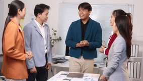 Business team celebrating success in office. Diverse team of Asian professionals expressing joy and camaraderie as they celebrate a shared accomplishment. - Powered by Shutterstock - Get 15% off with code: PIKWIZARD15