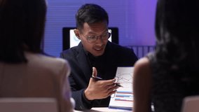 Businessman showing charts to colleague during office meeting. Confident businessman analyzing data charts, sharing insights with colleague during collaborative office meeting, strategic business. - Powered by Shutterstock - Get 15% off with code: PIKWIZARD15