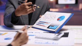 Business people analyzing financial charts and graphs, discussing company growth and planning investment strategies in a collaborative office. - Powered by Shutterstock - Get 15% off with code: PIKWIZARD15