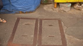 Casual city walk sandals, walking through busy city streets this summer, feet in sandals casually passing manholes on city sidewalk, summertime urban walk capturing feet and city life in casual - Powered by Shutterstock - Get 15% off with code: PIKWIZARD15