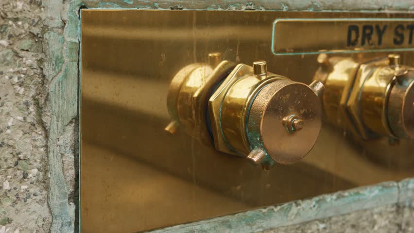 Fire inlet check, facility manager inspects fire inlet during maintenance, routine check of bronze fire inlet by facility personnel, maintenance worker conducts inspection of bronze fire inlet cap - Powered by Shutterstock - Get 15% off with code: PIKWIZARD15