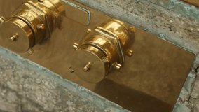 Closeup emergency standpipe coupling insitu inside concrete frame, fire safety trainer demonstrates attachment and function, warm metallic luster and functional hardware emphasized, training scenario - Powered by Shutterstock - Get 15% off with code: PIKWIZARD15